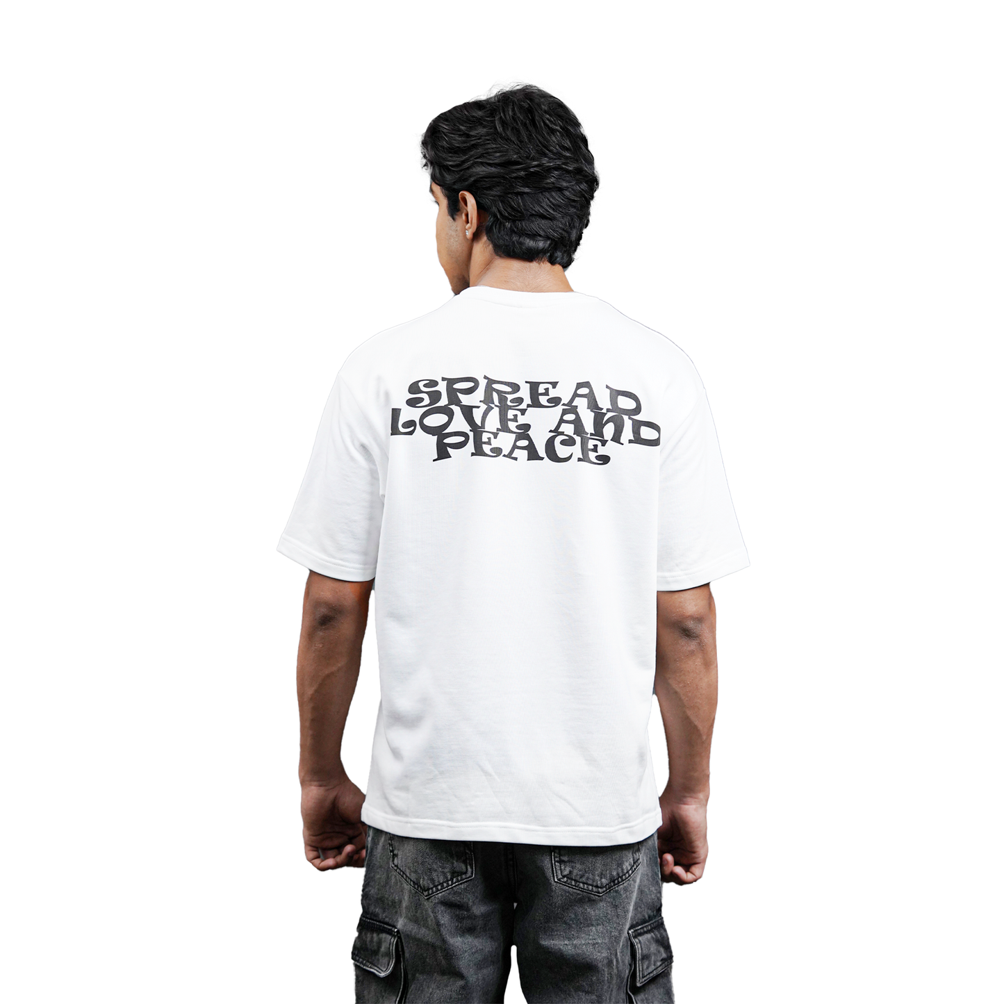 model with black hair wearing white tshirt with print design "spread love and peace" in black color in plane white background