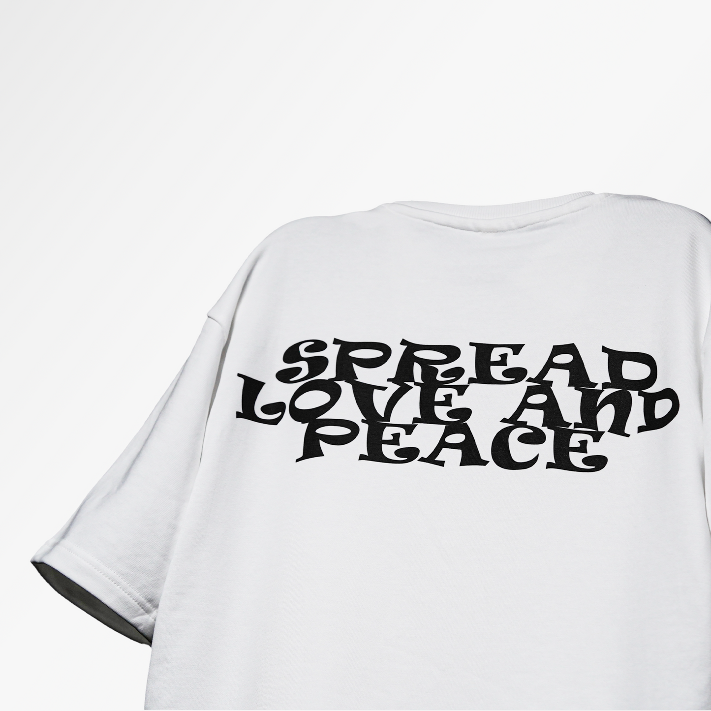 floating tshirt in studio background with black text design "spread peace and love" on the back side of the tshirt