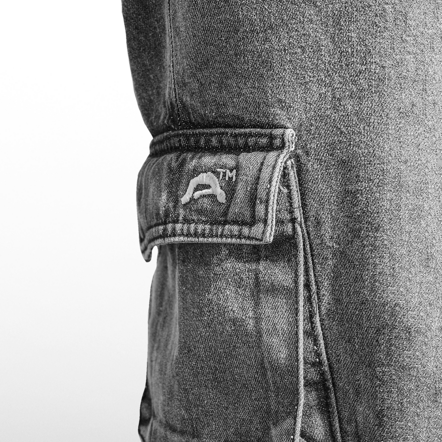 close up image of the pocket with embroidery trademark of insanity on white background