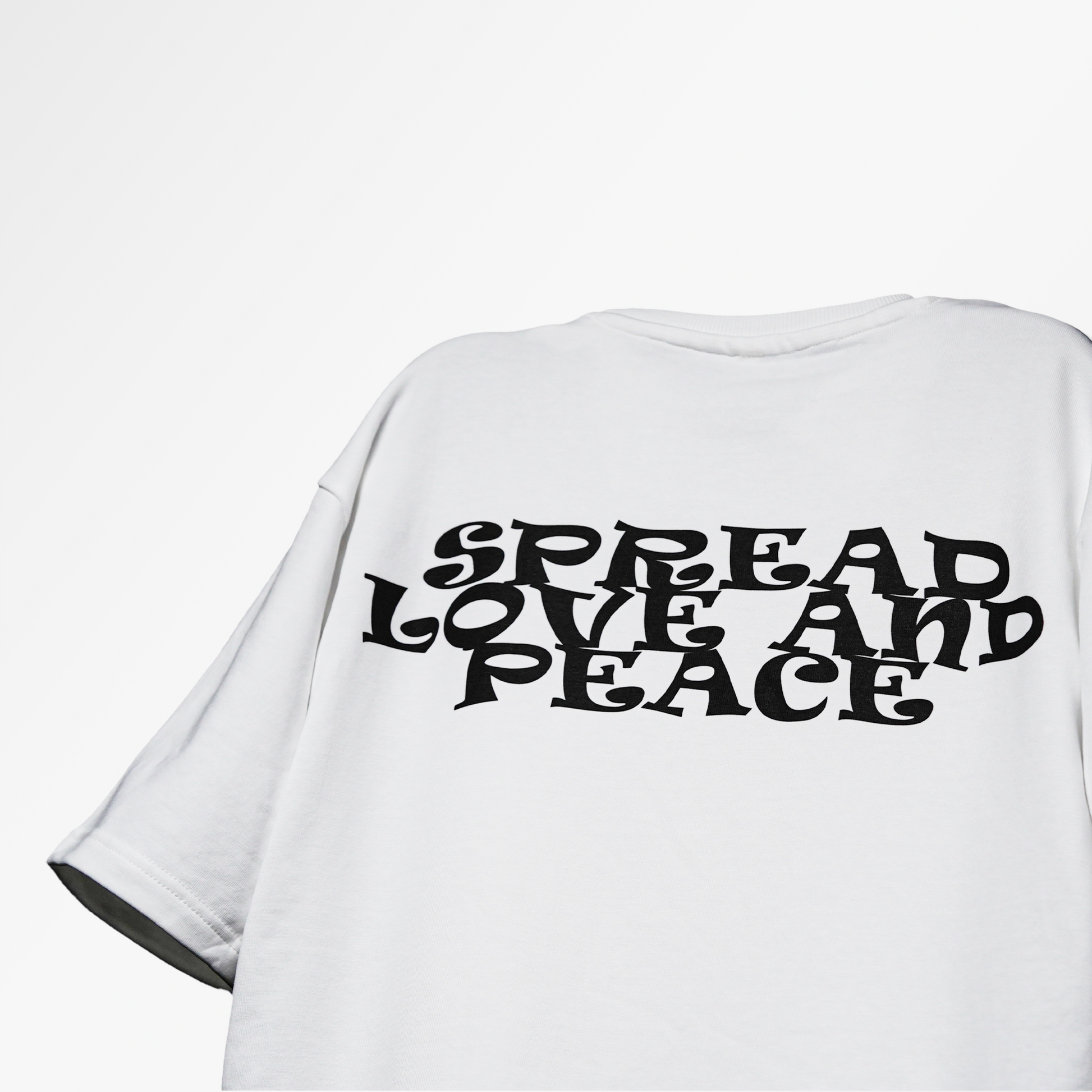 floating tshirt in studio background with black text design "spread peace and love" on the back side of the tshirt